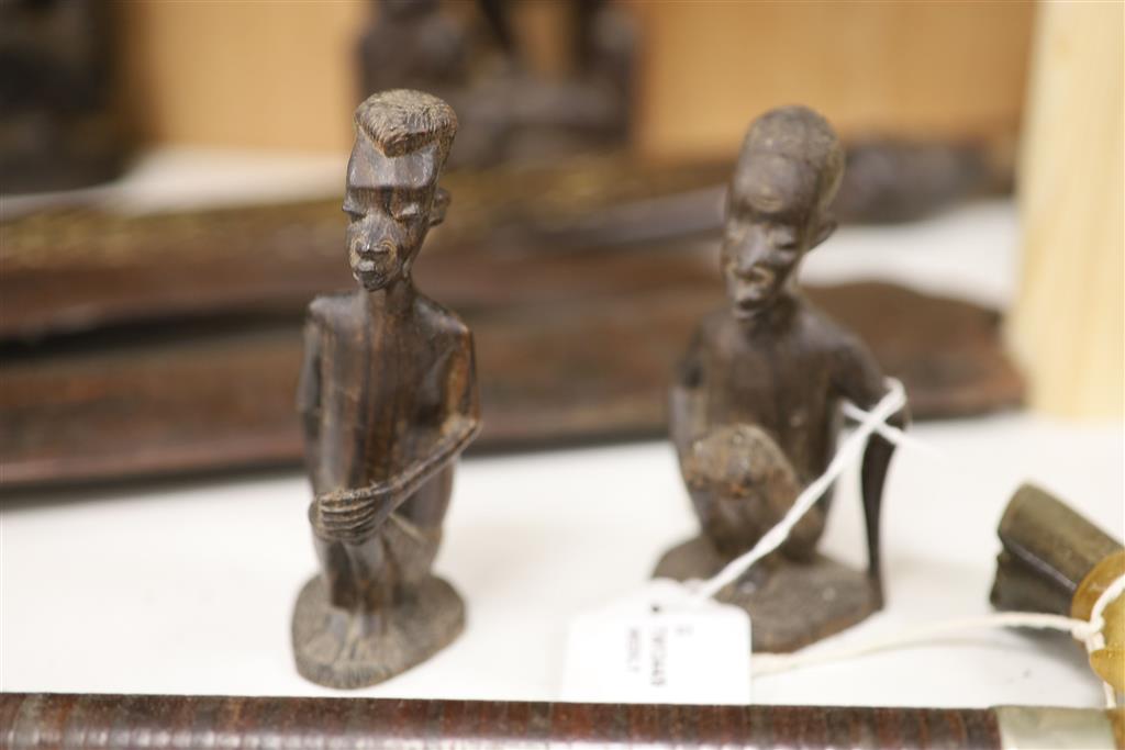 Ethnographia, a collection of various wood carvings, including an African tall female fertility figure,